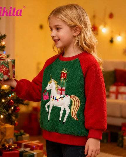 Mädchen trägt einen festlichen, rot-grünen Einhorn Pullover mit dicker Applikation eines Einhorns und Sternen, perfekt für Weihnachten