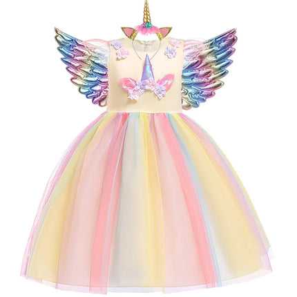 Mädchen in einem gelb-pinken Einhorn Kostüm Regenbogen Tutu-Kleid mit Stirnband und Flügeln, lachend und spielend